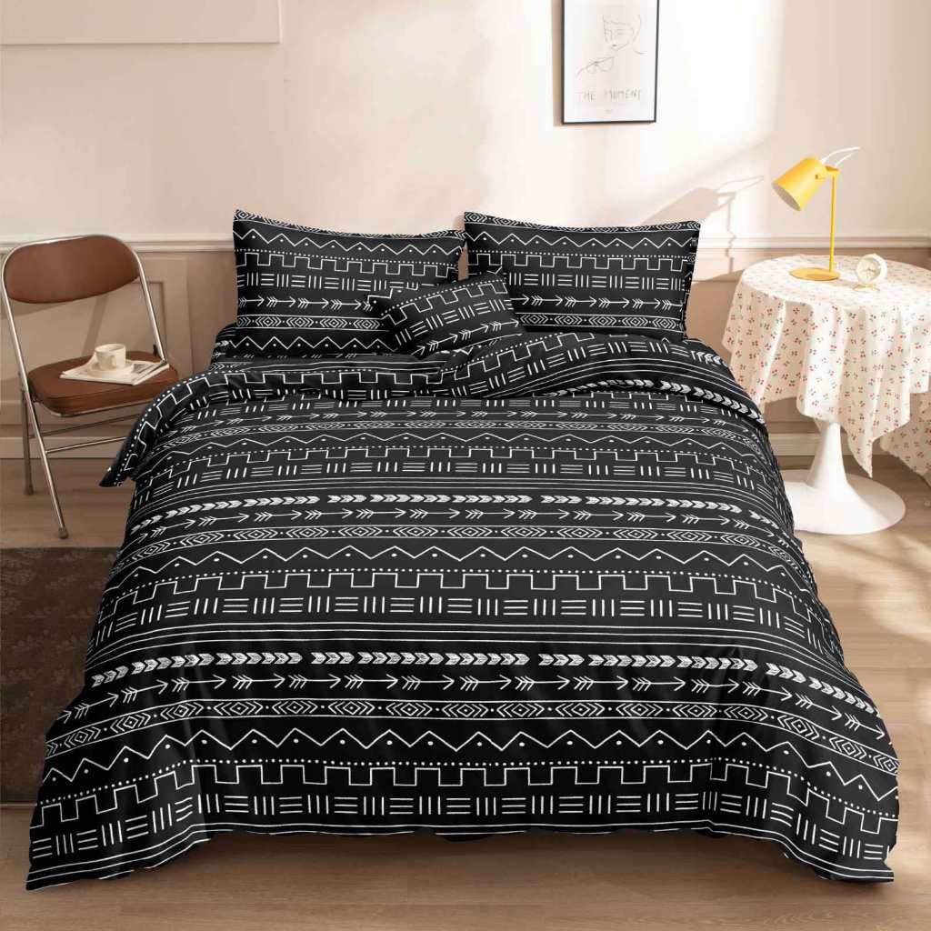 Black Boho printed bedsheet with white Aztec tribal pattern on bed