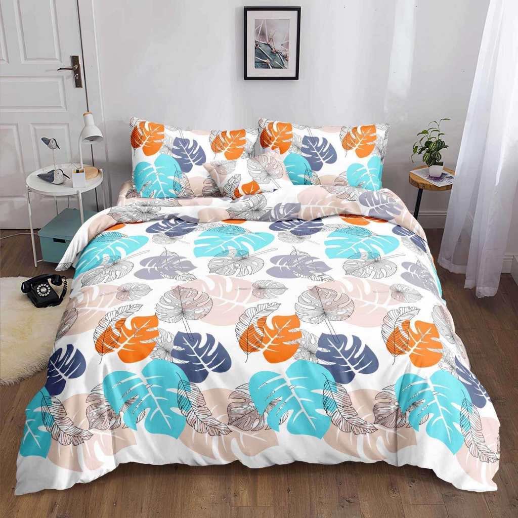 Light Monstera Bedsheet turquoise orange and navy monstera print on bed